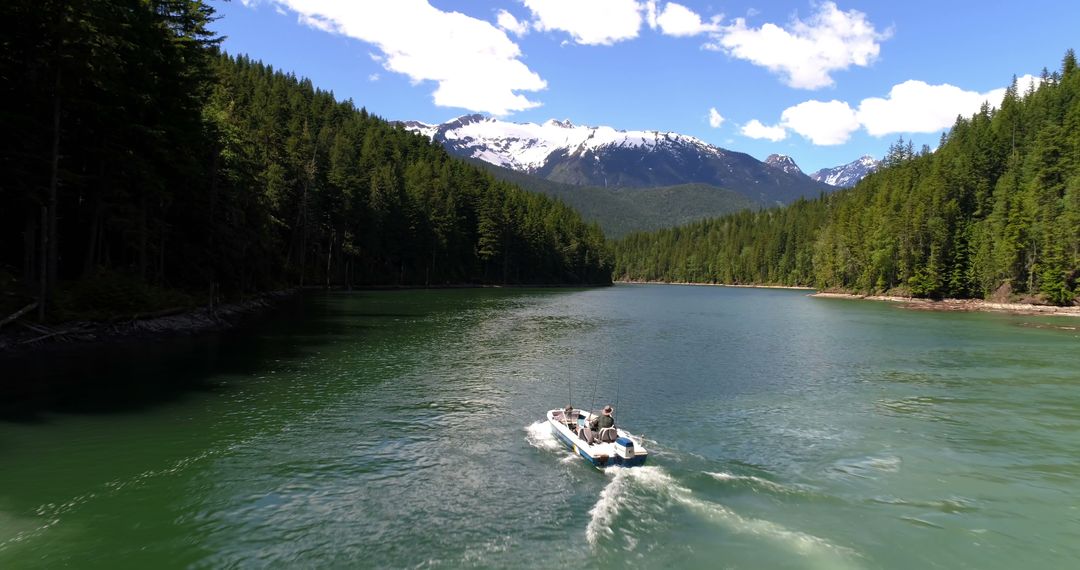 Boat on a Calm River with Mountain and Forest Scenery - Free Images, Stock Photos and Pictures on Pikwizard.com