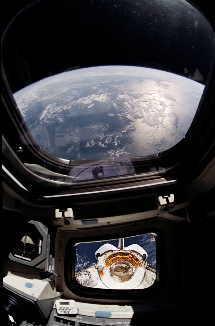 Astronauts Performing EVA from Space Shuttle Discovery Viewed from Cockpit - Free Images, Stock Photos and Pictures on Pikwizard.com