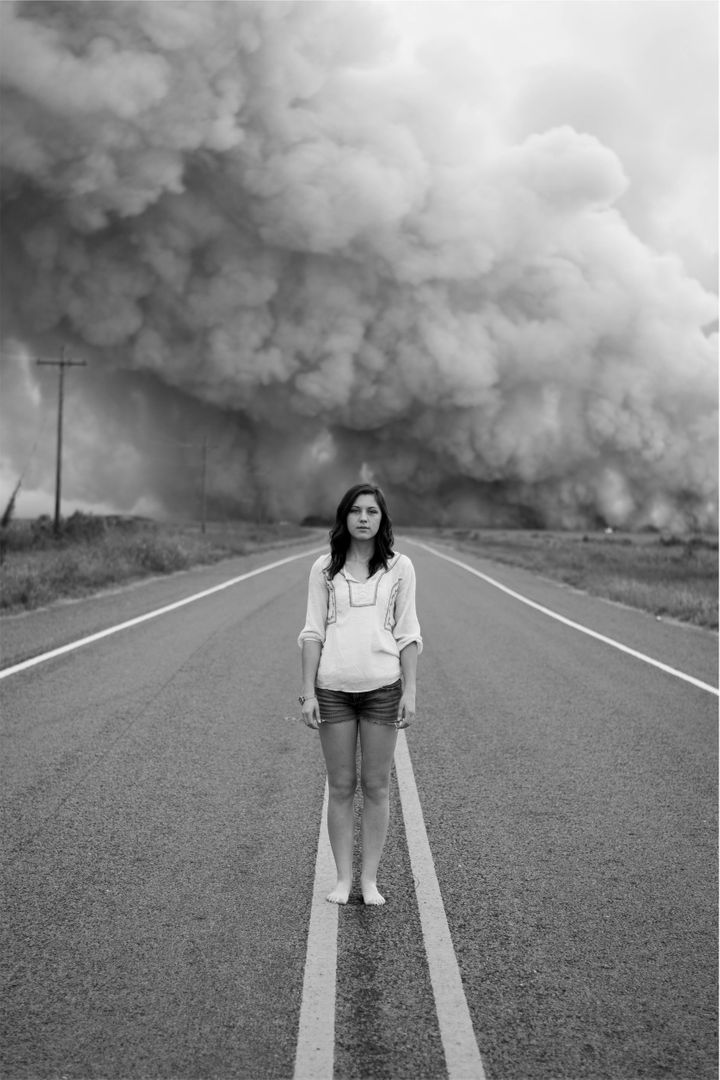 Portrait of Woman Standing on Road Amidst Dramatic Smoke Cloud - Free Images, Stock Photos and Pictures on Pikwizard.com