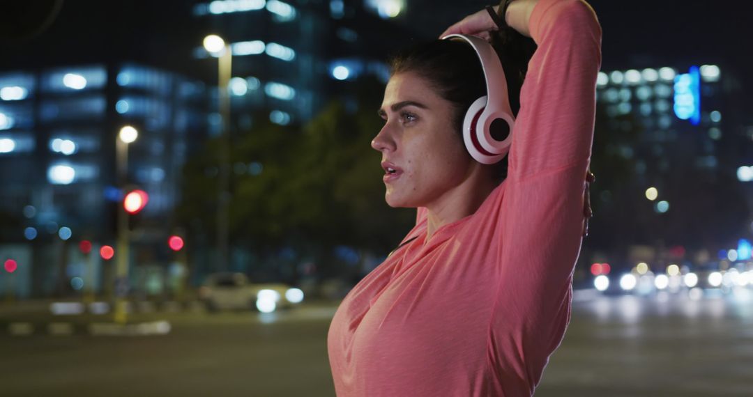 Focused Female Runner Stretching at Night - Free Images, Stock Photos and Pictures on Pikwizard.com