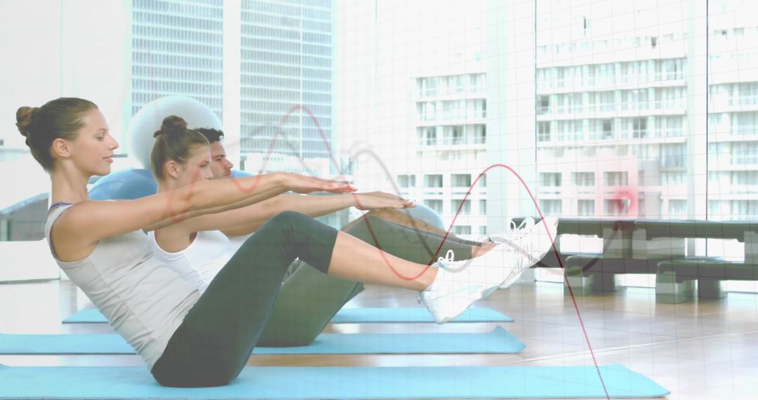 Group Pilates Workout with V-Sit Exercise in Bright Studio