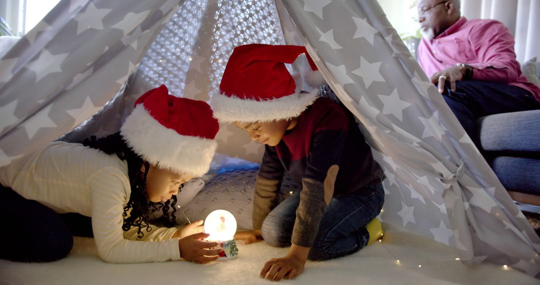 Children with Santa Hats under Blanket Fort at Christmas - Free Images, Stock Photos and Pictures on Pikwizard.com