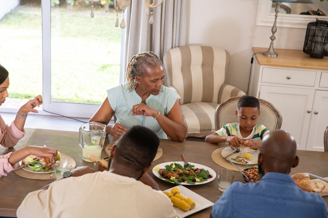 Multigenerational Family Gathering Around Dining Table Eating Together