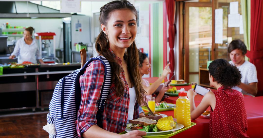 Smiling Student in School Cafeteria Holding Lunch Tray - Free Images, Stock Photos and Pictures on Pikwizard.com