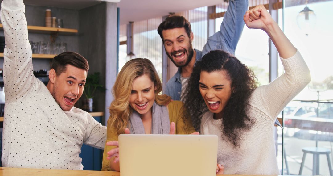 Diverse Group Celebrating with Team Success at Cafe