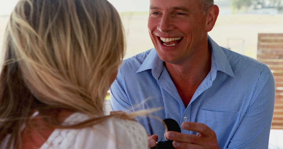 Smiling Man Proposing to His Girlfriend with Engagement Ring - Free Images, Stock Photos and Pictures on Pikwizard.com