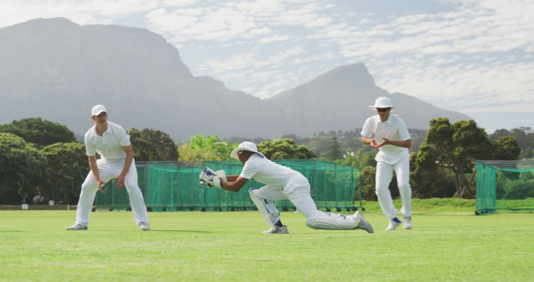 Cricket Players Practicing on Field with Mountain Background - Free Images, Stock Photos and Pictures on Pikwizard.com