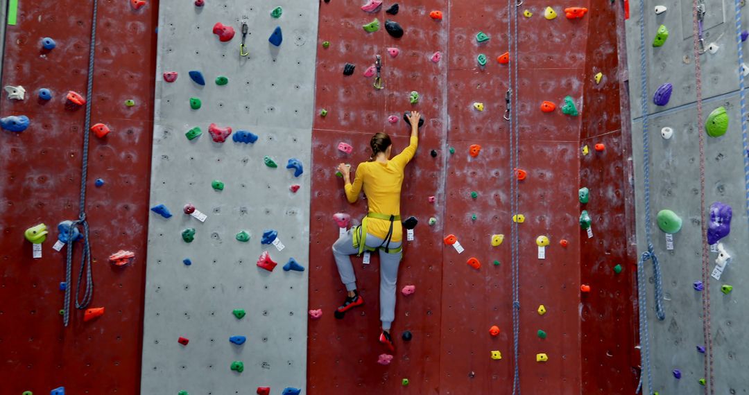 Person climbing indoor rock wall - Free Images, Stock Photos and Pictures on Pikwizard.com