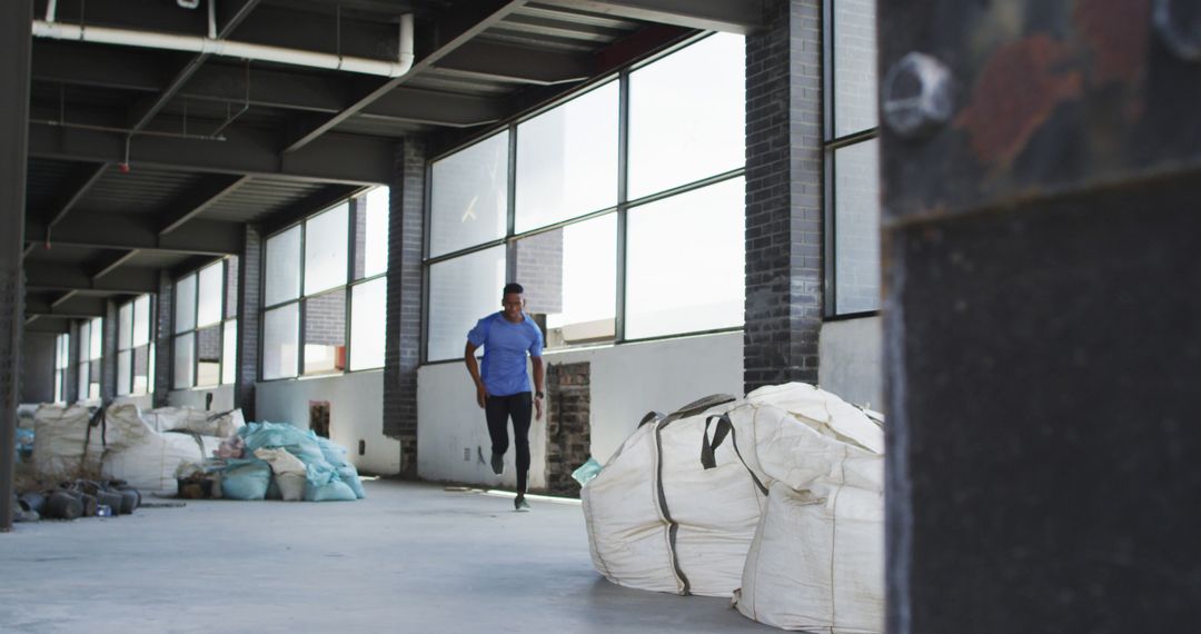 Man Running in Industrial Warehouse for Fitness Training - Free Images, Stock Photos and Pictures on Pikwizard.com