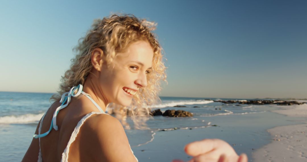 Joyful Young Woman on a Sandy Beach at Sunset - Free Images, Stock Photos and Pictures on Pikwizard.com