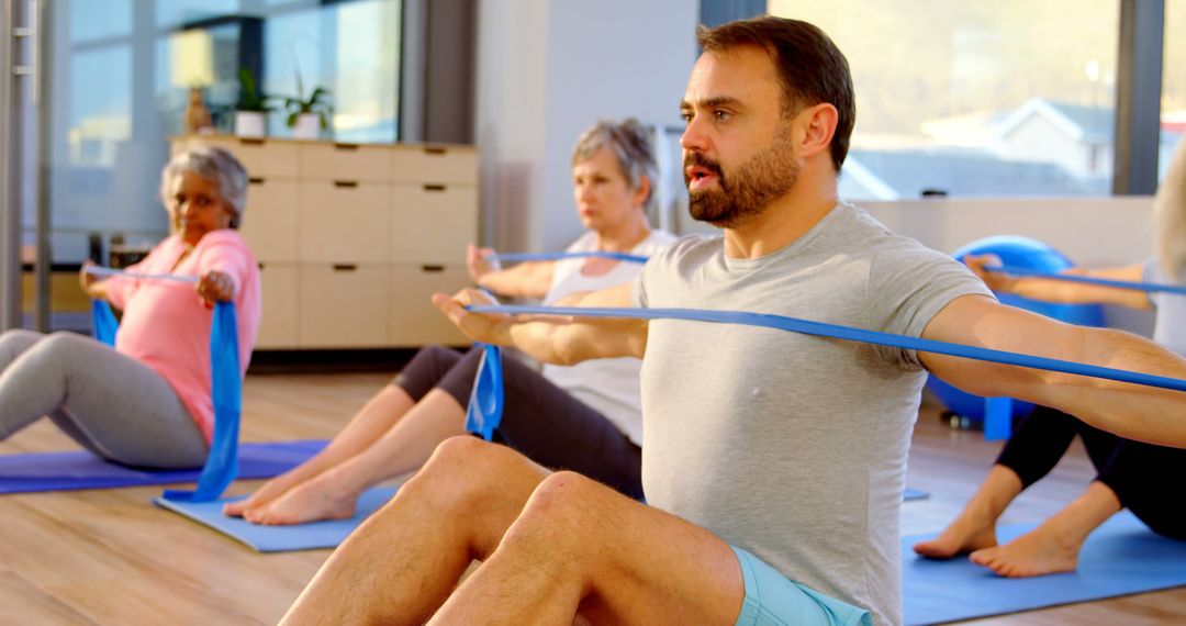 Diverse Fitness Class Engaging in Resistance Band Exercises