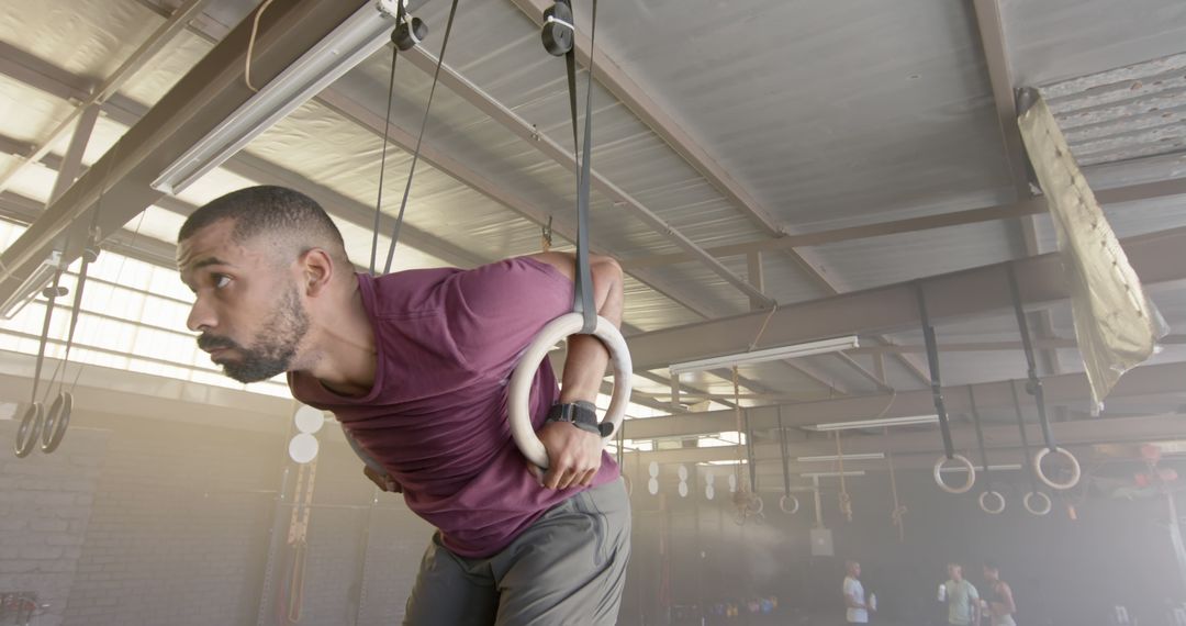 Determined Athlete Training on Gymnastic Rings in Industrial Setting - Free Images, Stock Photos and Pictures on Pikwizard.com