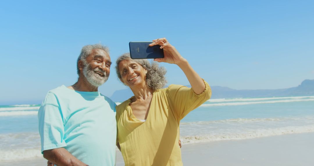 Senior Couple Smiling and Taking Selfie at Beach in Sunny Weather
