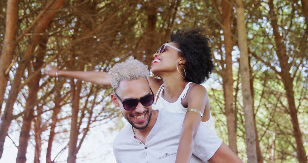 A joyful African American couple shares a piggyback ride during a carefree, romantic day. - Free Images, Stock Photos and Pictures on Pikwizard.com