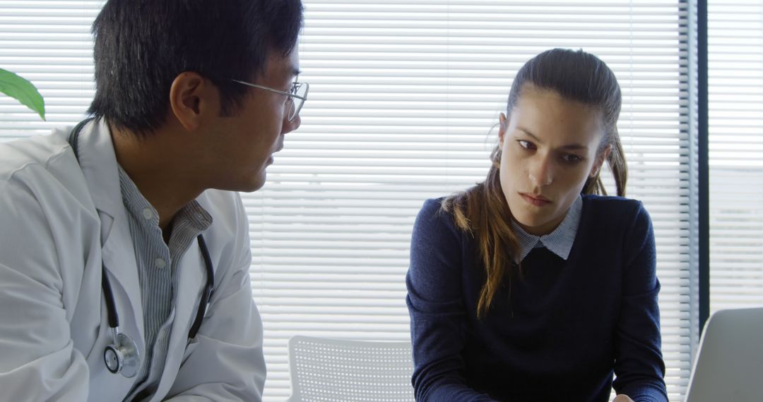 Doctor Discussing Diagnosis with Concerned Patient in Medical Office - Free Images, Stock Photos and Pictures on Pikwizard.com