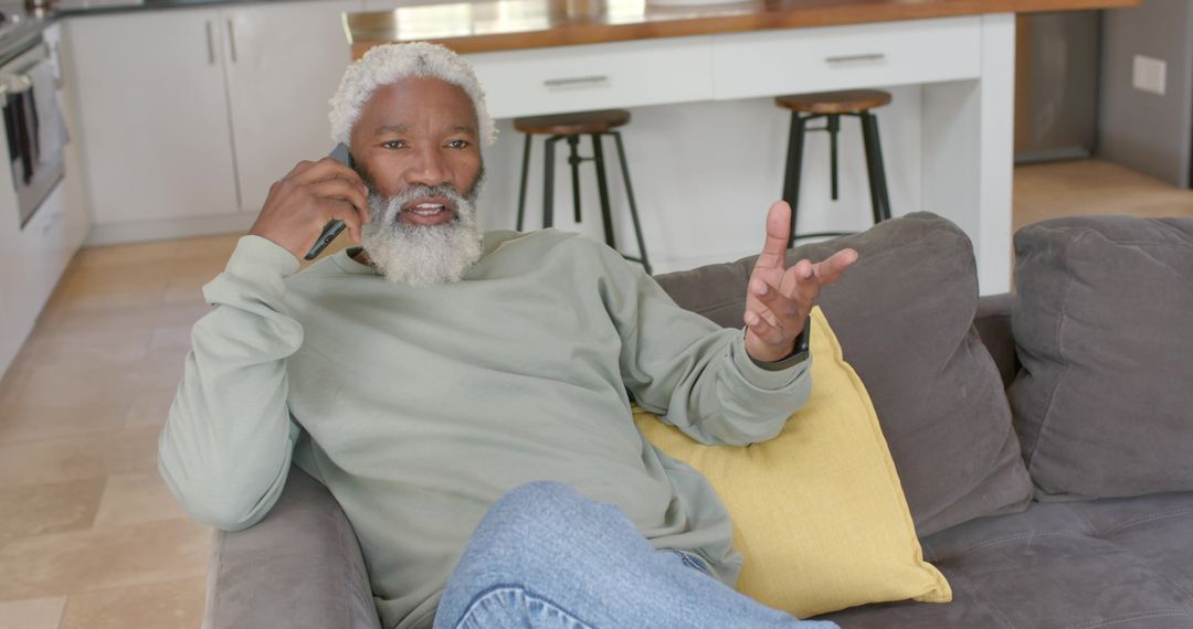 Senior Man Using Smartphone at Home Displaying Relaxed Lifestyle