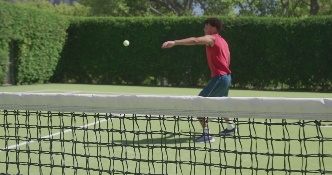 Teen Boy Playing Tennis on Outdoor Court - Free Images, Stock Photos and Pictures on Pikwizard.com