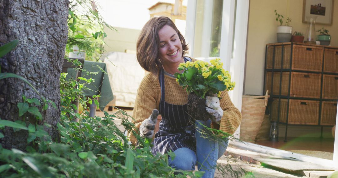 Woman Gardening in Backyard Holding Yellow Flowers - Free Images, Stock Photos and Pictures on Pikwizard.com