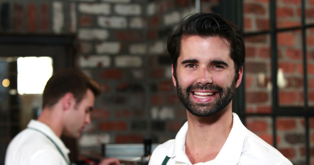 Male Barista Smiling in Modern Coffee Shop Environment - Free Images, Stock Photos and Pictures on Pikwizard.com