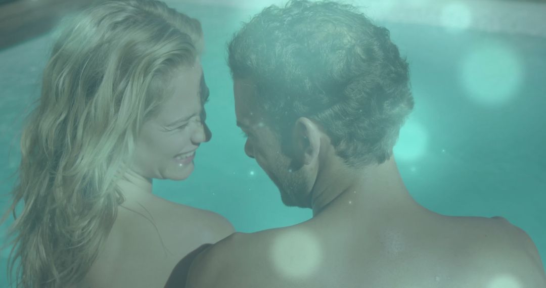 Couple Relaxing in Pool with Lens Flare Highlighting Intimate Moments