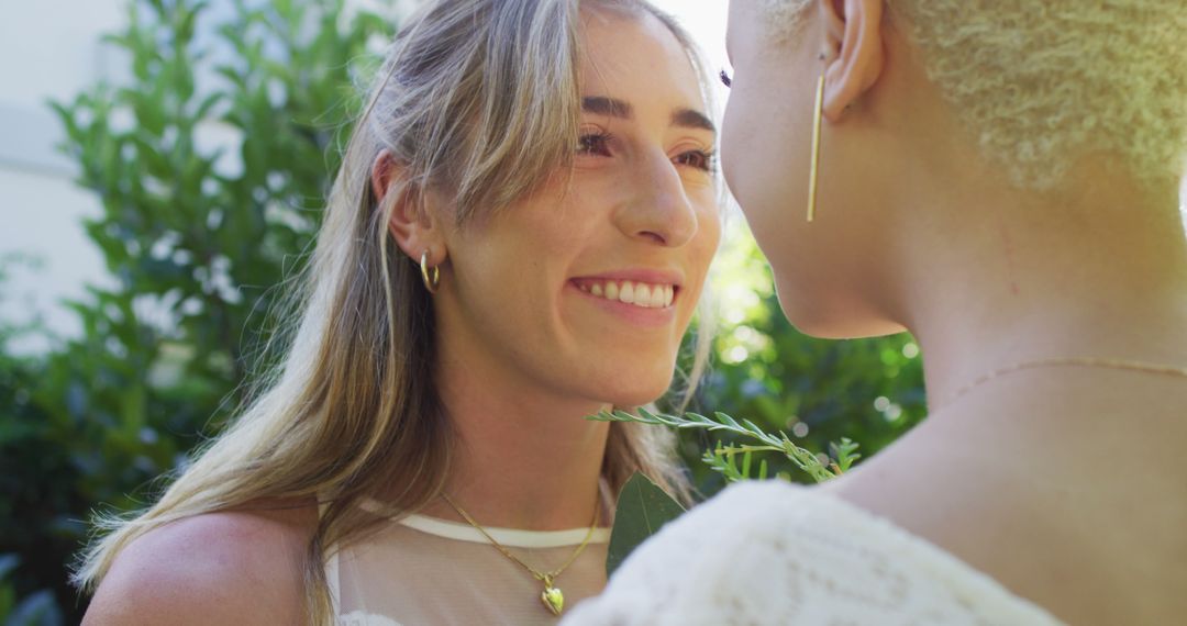 Smiling Women Embracing in Garden Setting - Free Images, Stock Photos and Pictures on Pikwizard.com