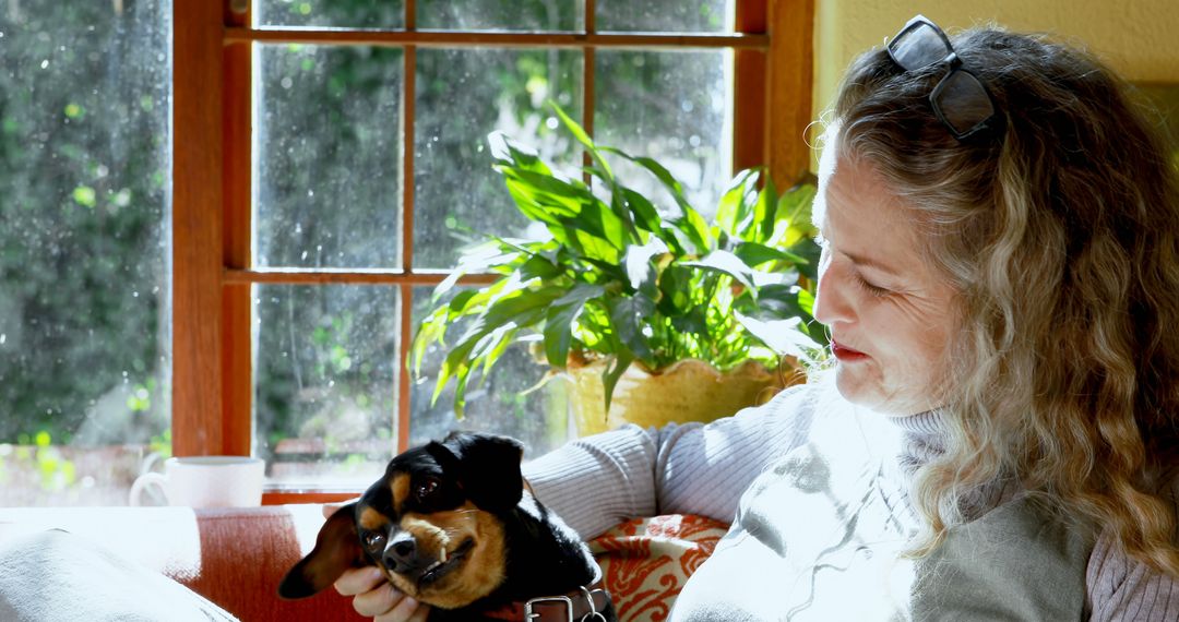 Elderly Woman Relaxing with Beloved Dog at Home - Free Images, Stock Photos and Pictures on Pikwizard.com