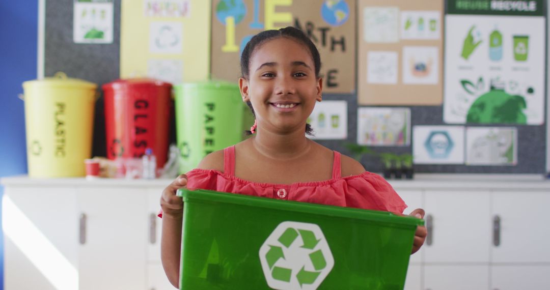 Smiling Girl Holding Green Recycling Bin in Classroom - Free Images, Stock Photos and Pictures on Pikwizard.com