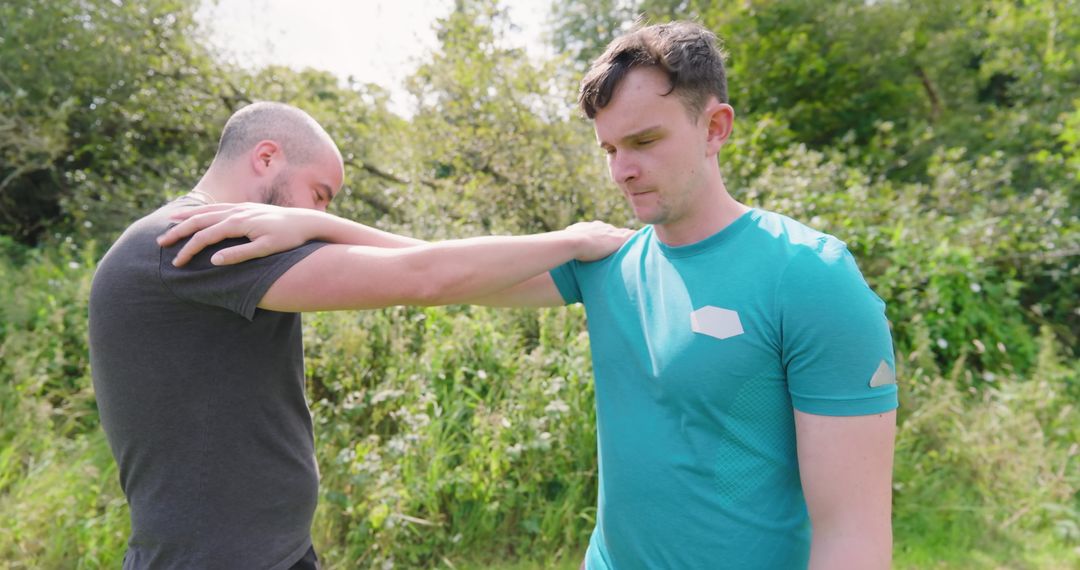 Two Men Practicing Self-Defense Techniques in Sunny Park