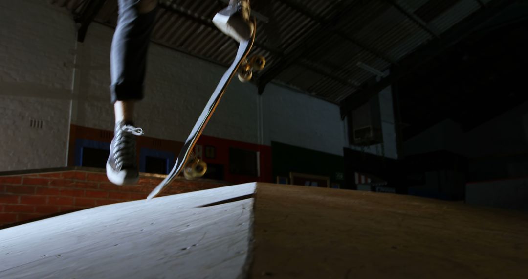 Skateboarder Performing Trick in Indoor Skatepark at Night - Free Images, Stock Photos and Pictures on Pikwizard.com