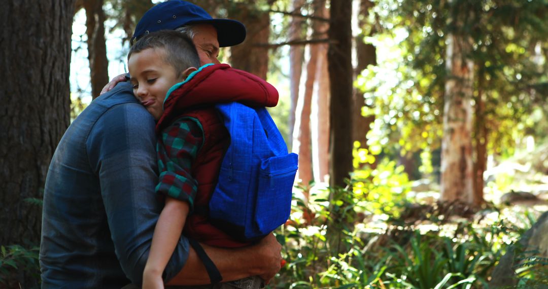 Father Embracing Sleeping Child in Forest during Outdoor Adventure - Free Images, Stock Photos and Pictures on Pikwizard.com