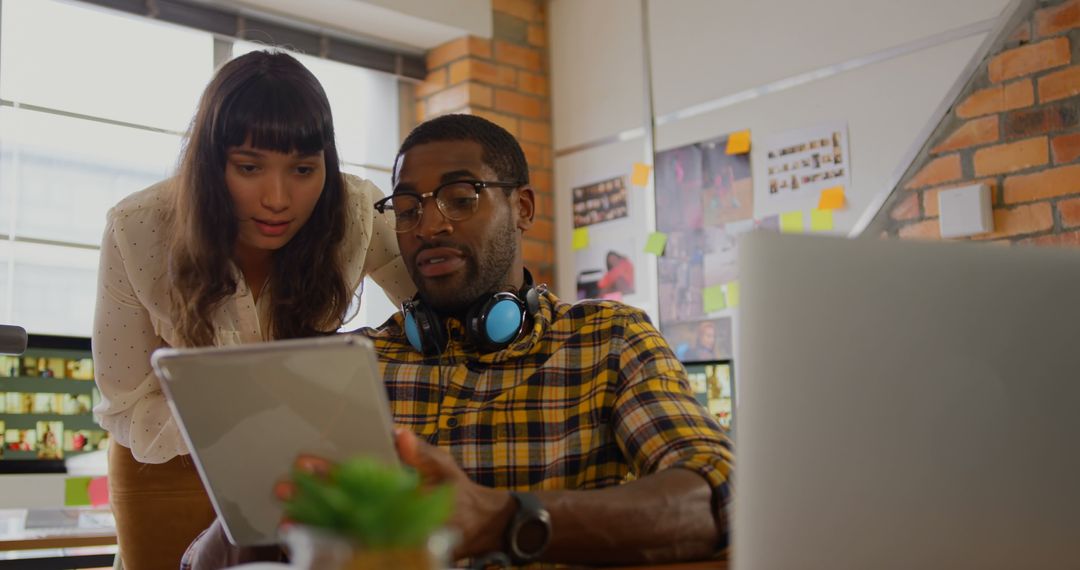 Collaborative Graphic Designers Engaged in Creative Discussion