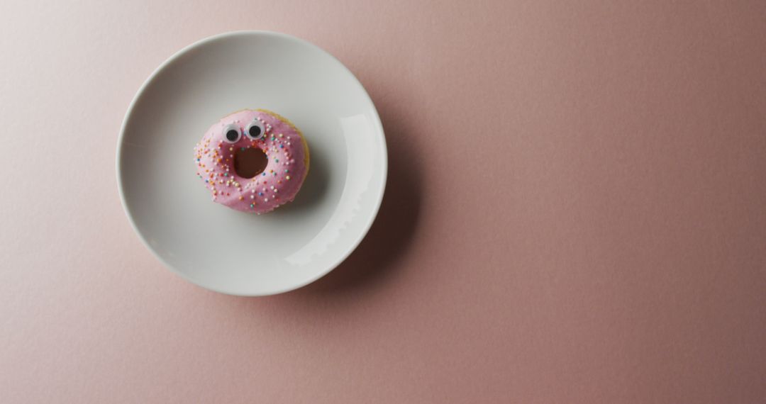 Cute Doughnut with Sprinkles and Eyes on White Plate - Free Images, Stock Photos and Pictures on Pikwizard.com