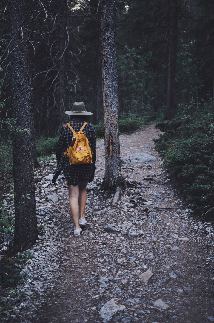 Woman Hiking Alone in Forest with Yellow Backpack - Free Images, Stock Photos and Pictures on Pikwizard.com