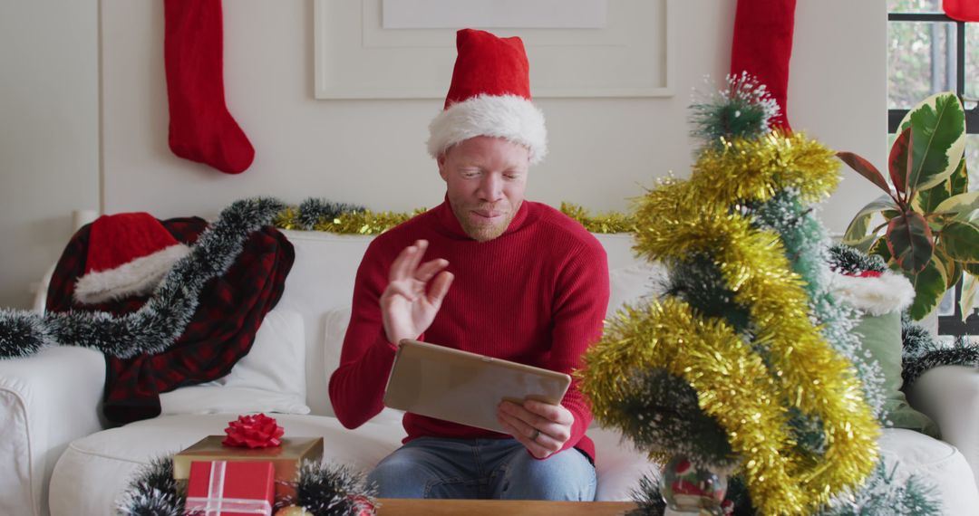 Man Celebrating Virtual Christmas With Family on Tablet - Free Images, Stock Photos and Pictures on Pikwizard.com