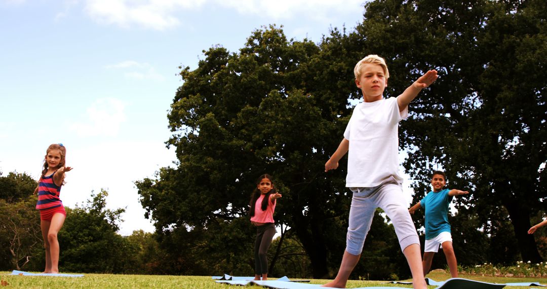 Group of Children Practicing Yoga Outdoors in Park - Free Images, Stock Photos and Pictures on Pikwizard.com