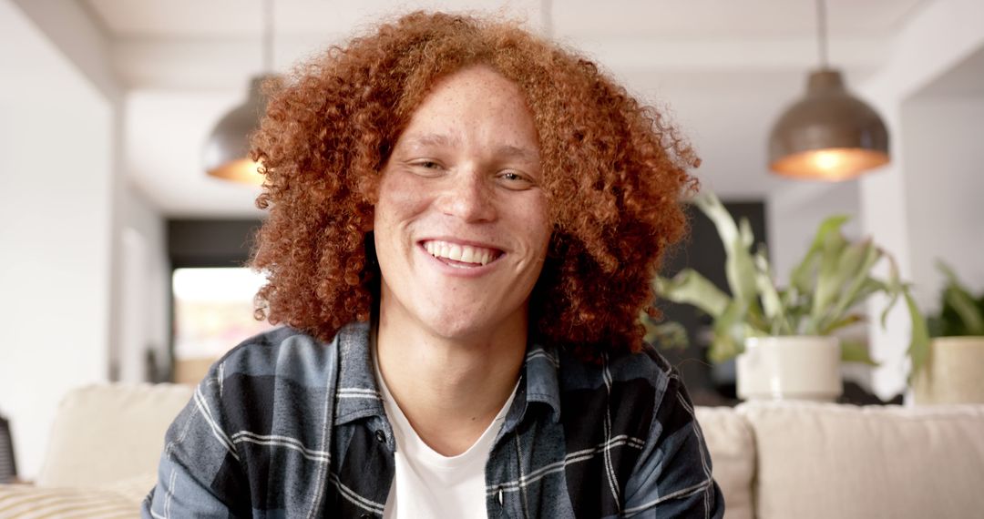 Portrait of smiling young man with curly red hair indoors - Free Images, Stock Photos and Pictures on Pikwizard.com