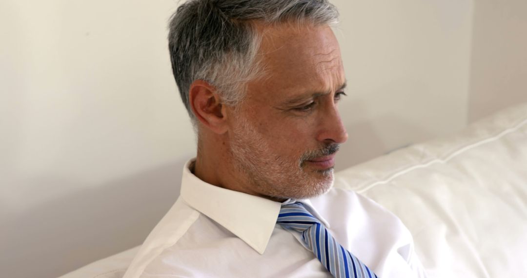 Mature Businessman in Thoughtful Mood on Sofa - Free Images, Stock Photos and Pictures on Pikwizard.com