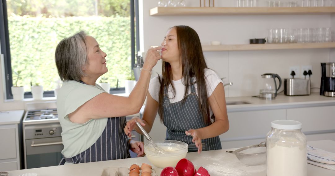 Grandmother and Granddaughter Enjoying Baking Time in Kitchen