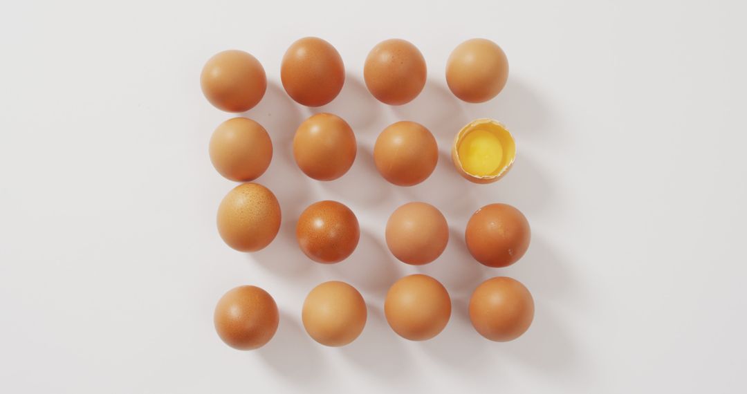 Arrangement of Brown Eggs with One Half-Broken Egg