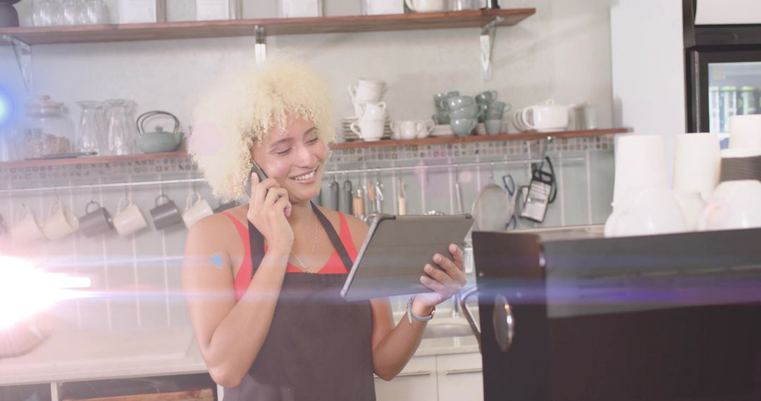 Cheerful Barista Managing Orders on Tablet While Multitasking