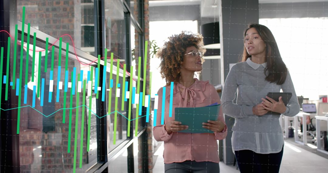 Businesswomen Analyzing Data on Digital Screen in Modern Office - Free Images, Stock Photos and Pictures on Pikwizard.com