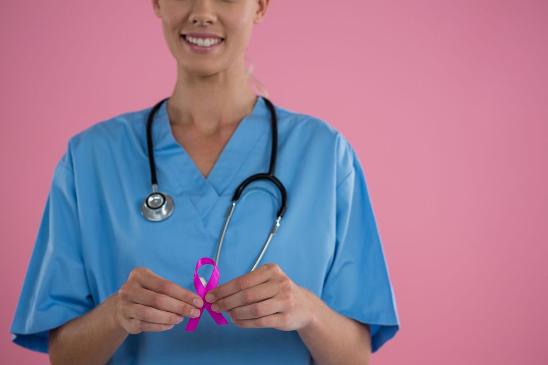 Female Doctor Holding Breast Cancer Awareness Ribbon - Free Images, Stock Photos and Pictures on Pikwizard.com
