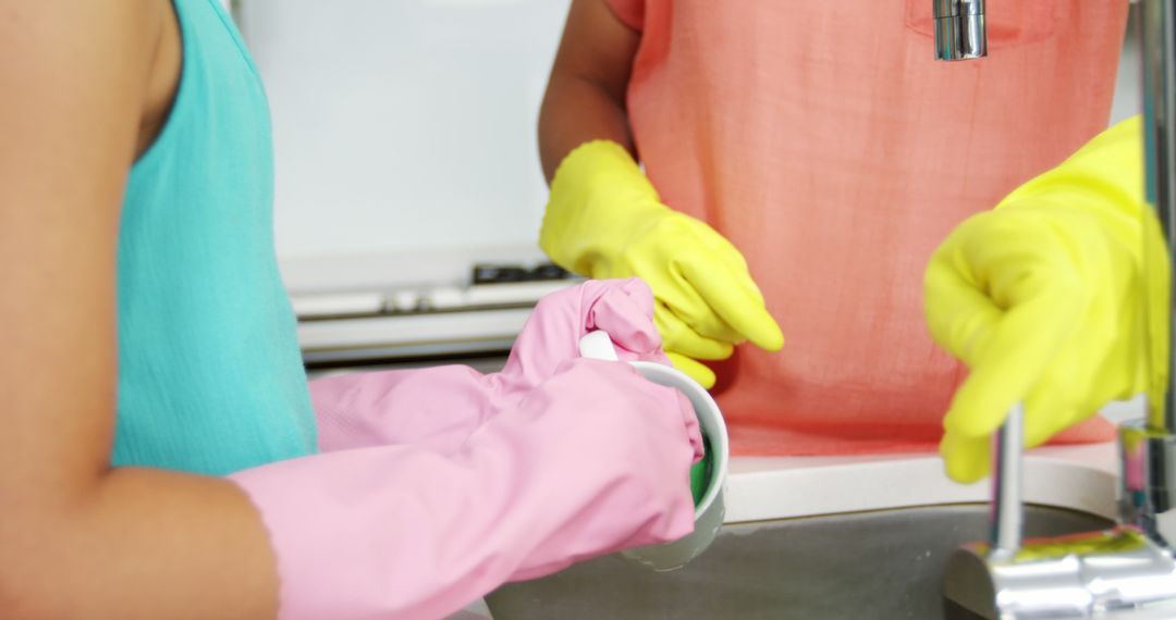 Close-Up of People Washing Dishes in Kitchen with Gloves - Free Images, Stock Photos and Pictures on Pikwizard.com