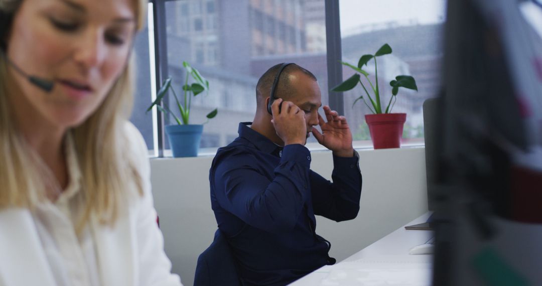 Professional Call Center Team Using Headsets in Modern Office