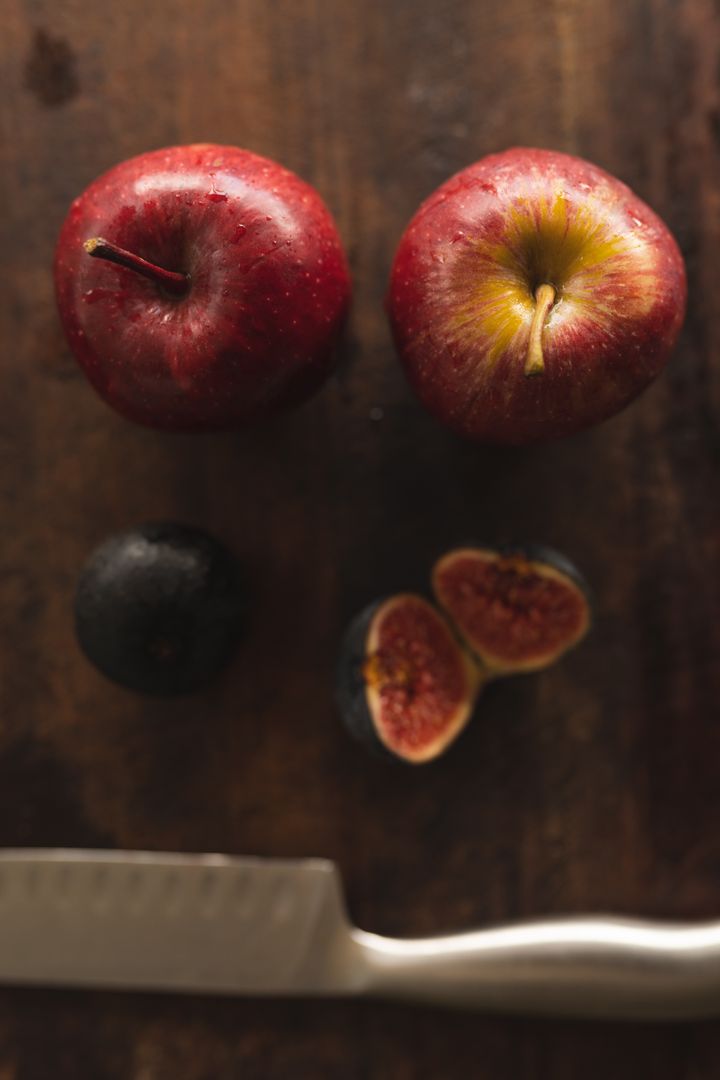 Close up view of apples and fig on wooden table - Free Images, Stock Photos and Pictures on Pikwizard.com