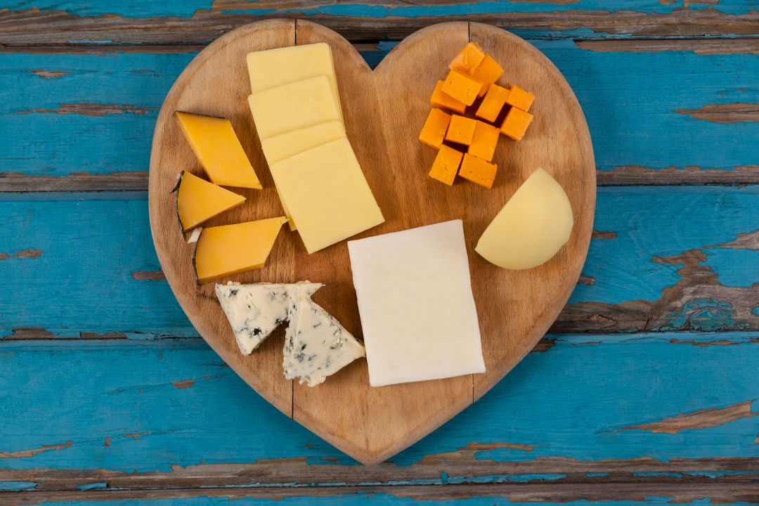 Assorted Cheeses on Heart Shaped Wooden Board - Free Images, Stock Photos and Pictures on Pikwizard.com