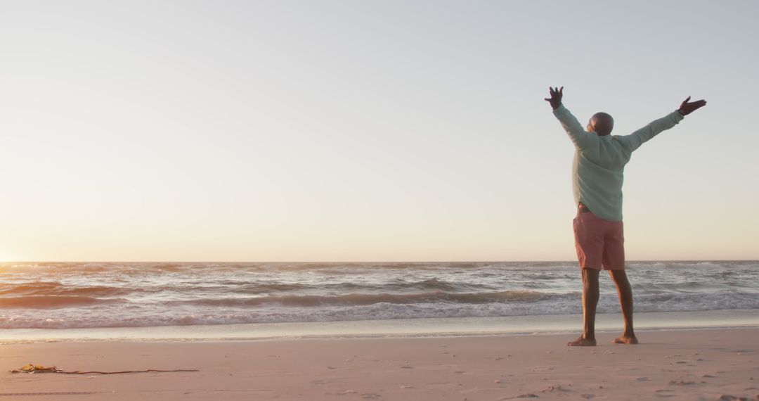 Man Rejoicing at Beach During Sunset with Open Arms - Free Images, Stock Photos and Pictures on Pikwizard.com