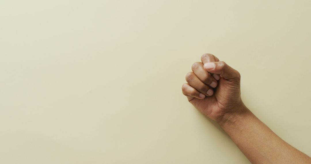 Isolated Hand Fist Gesture Against Neutral Background - Free Images, Stock Photos and Pictures on Pikwizard.com