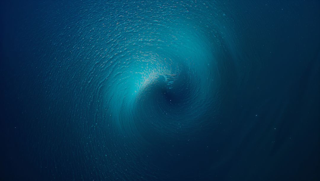 Swirling Deep Ocean Vortex with Turquoise Halo, Radiating Bubbles and Spiral Motion