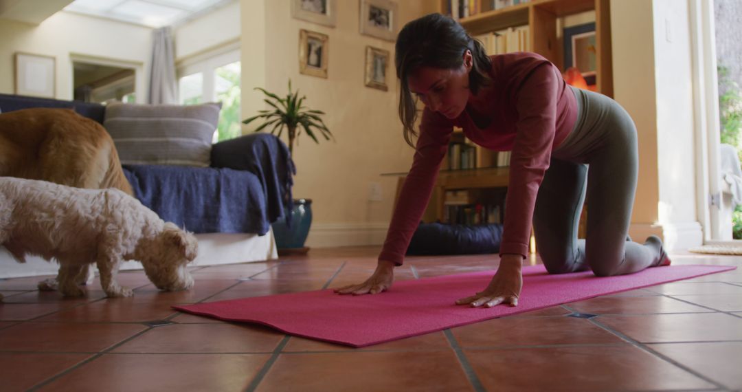 Caucasian woman practicing yoga with her pet dogs at home - Free Images, Stock Photos and Pictures on Pikwizard.com